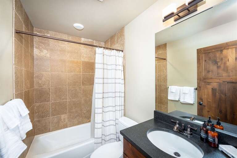 A full bathroom with tub/shower combination serves the top floor bedrooms | Upper Level