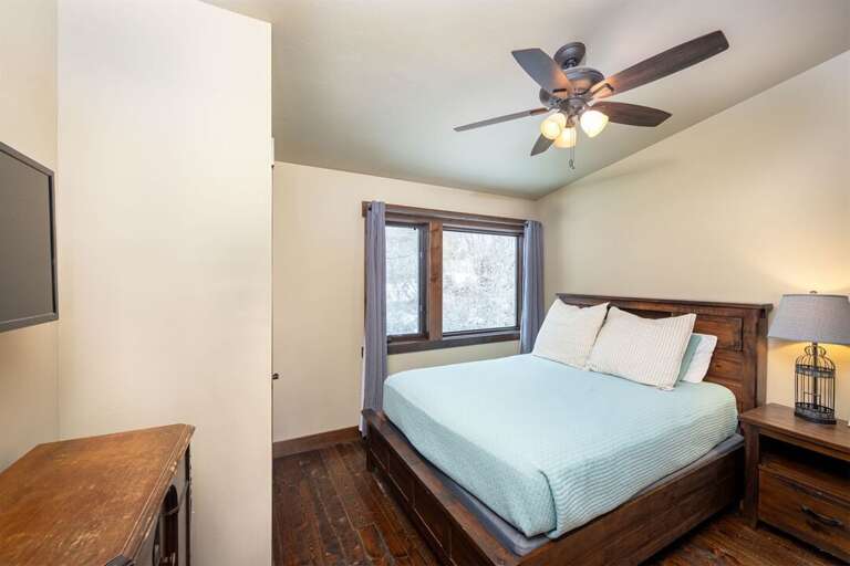 Thoughtfully decorated, Bedroom 3 also offers a private television | Upper Level