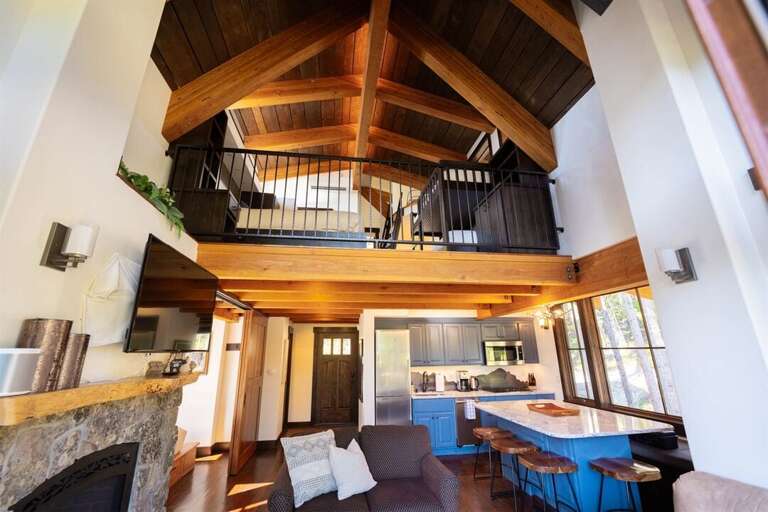 The stunning lofted ceiling and custom architecture beautifully frame the living space | Main Level