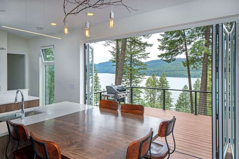 Access the patio from the kitchen and living room, and take in amazing views of Whitefish Lake | Main Floor