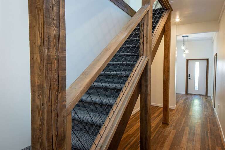 The bottom floor has a modern rustic esthetic and is the main entryway of the home | Bottom floor