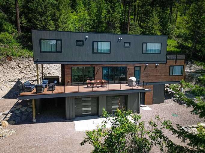 This beautifully modern home offers quick access to Whitefish Lake in a peaceful treetop setting | Exterior