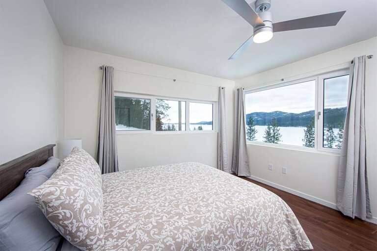 This bedroom on the second floor of the home, features a queen size bed, ensuite & incredible views | Main Floor