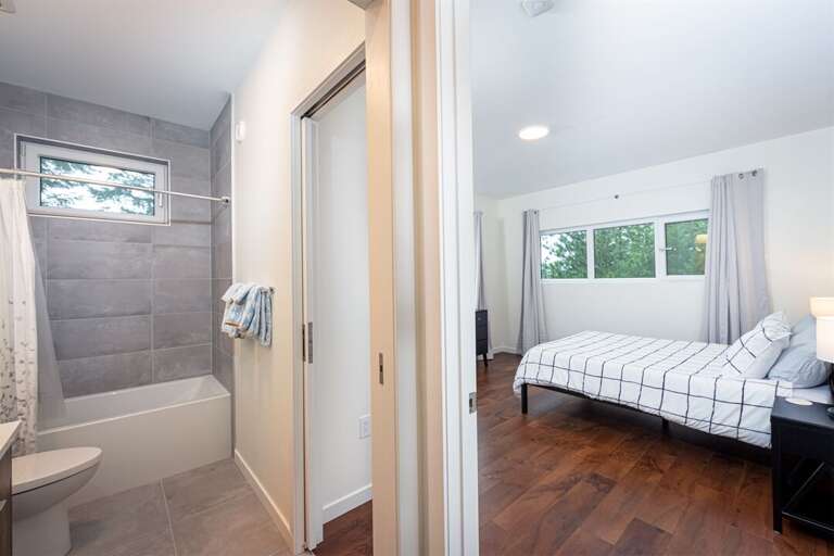 The queen bedroom has access to the shared guest bathroom | Upper Level