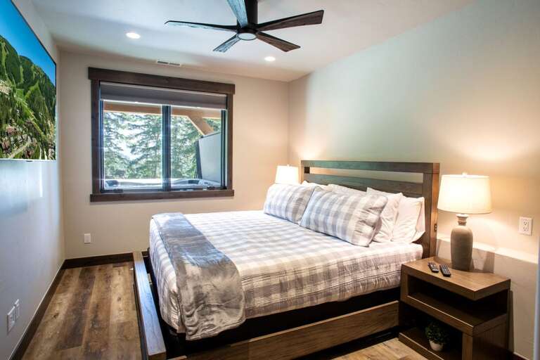 Fifth bedroom with king bed, 55" Smart TV, and full bathroom | Lower Level