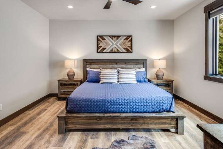 Second bedroom on main level with king bed, 55" Smart TV, and full bathroom | Middle Level