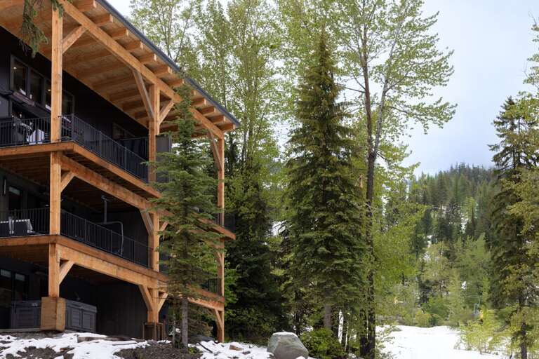Foliage abound at this incredible ski in/ ski out home | Exterior