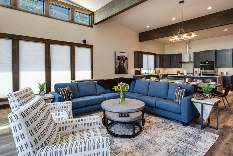 Great room with 10-seat dining table, 5 bar seats, gourmet kitchen, cozy living room and huge deck with outdoor seating and fire pit.