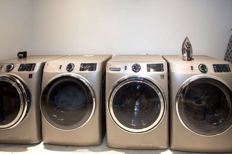 Laundry room with 2 full size washers & 2 full size dryers | Lower Level