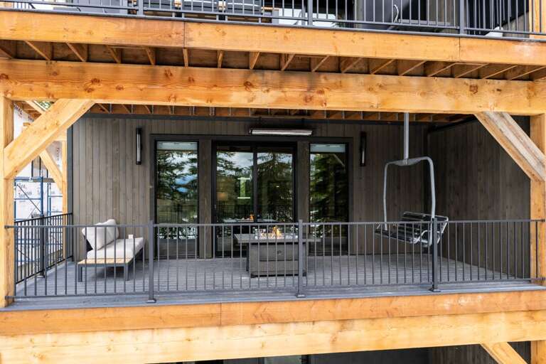 Middle deck, off the master bedroom with 2 lounge chairs, fire pit, and vintage ski chair!
