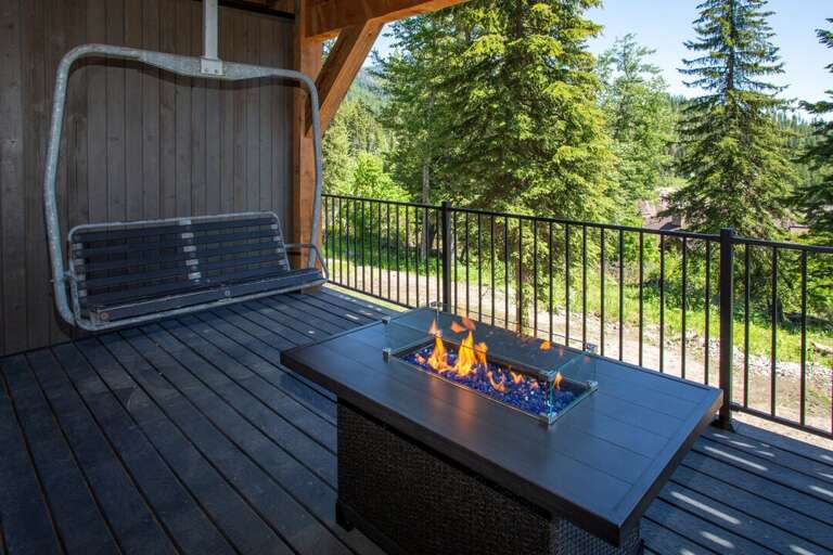 Middle deck, off the master bedroom with 2 lounge chairs, fire pit, and vintage ski chair!