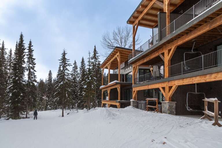 Multi-tiered design with exposed wood beams supporting the roof 
 and balconies creating a rustic yet contemporary aesthetic | Exterior