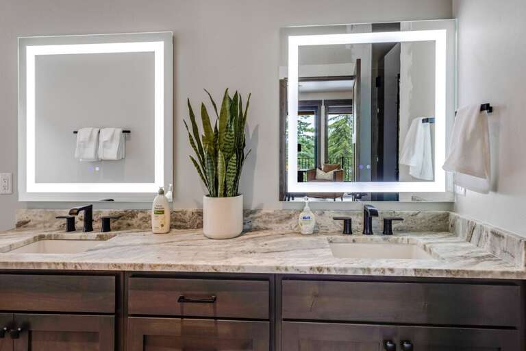 Primary bedroom bathroom with dual vanities, soaking tub, and big 3-valve shower | Middle Level