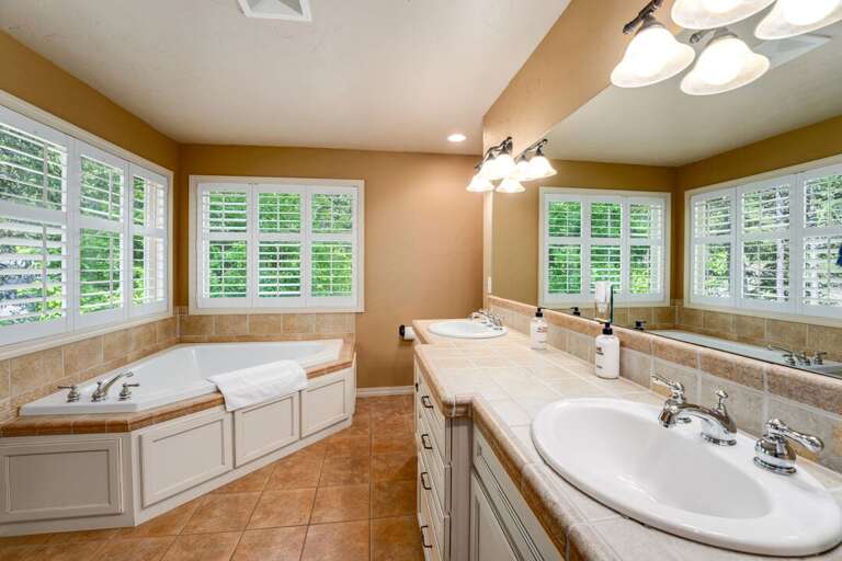 En Suite Bathroom with Dual Sinks and Large Tub | Main Level