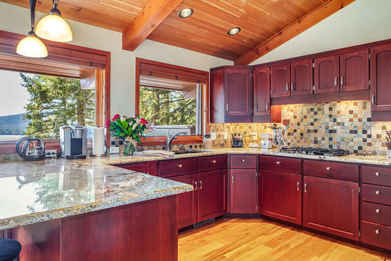 Gourmet kitchen with stainless appliances, including a gas stovetop, and hardwood flooring | Main Level