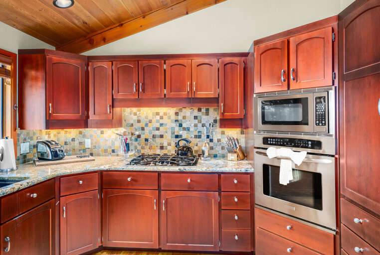 Gourmet kitchen with stainless appliances, including a gas stovetop, and hardwood flooring | Main Level