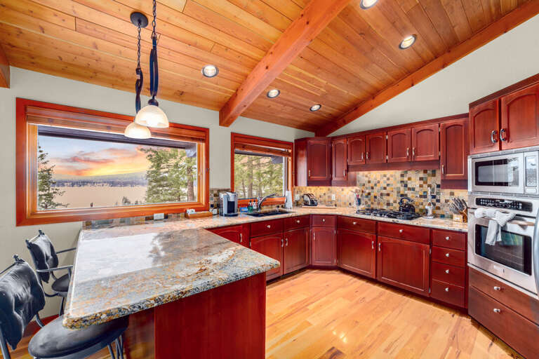 Gourmet kitchen with stainless appliances, including a gas stovetop, and hardwood flooring | Main Level