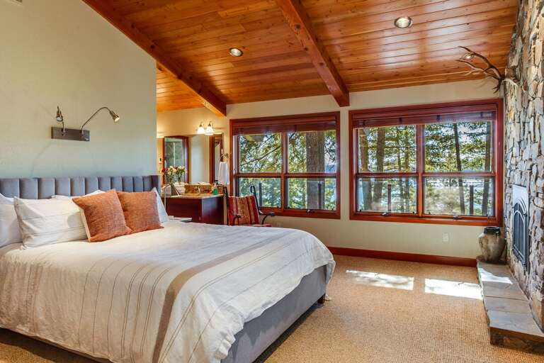 Grand Master suite on mail level with king bed, fireplace, office suite, and large master bathroom with stone shower and roman tub | Main Level