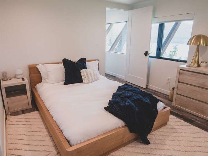 This bedroom offers a queen bed and private television | Lower Level