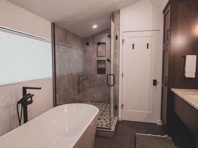 Enjoy a spa-like retreat in the master ensuite with soaker tub, custom tile shower, and double vanity | Upper Level