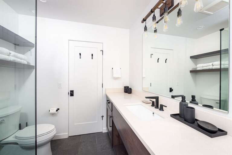 The main floor bathroom offers a custom tile shower | Main Level