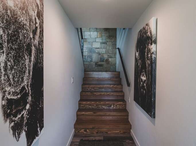 The mixture of stone, wood, and metal create a rich aesthetic throughout the home | Lower Level