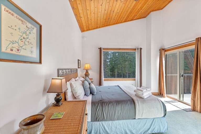 Bedroom 2 (Upper Level)  with queen bed, private deck access, and access to full shared bathroom