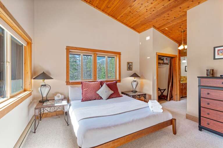 Master bedroom(Upper Level)  with king bed, deck access, and ensuite bathroom