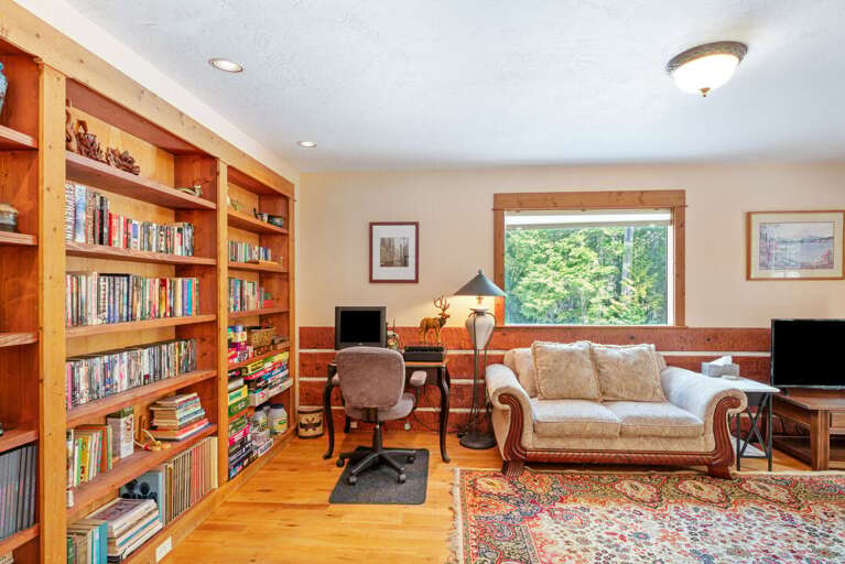 Office area with desk, additional seating, plenty of books and board games to enjoy