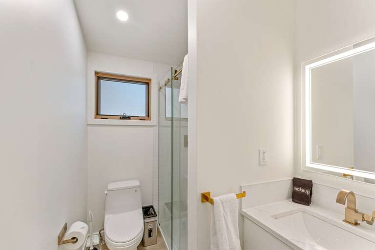 Full shared bath with a lighted mirror and shower Main Level