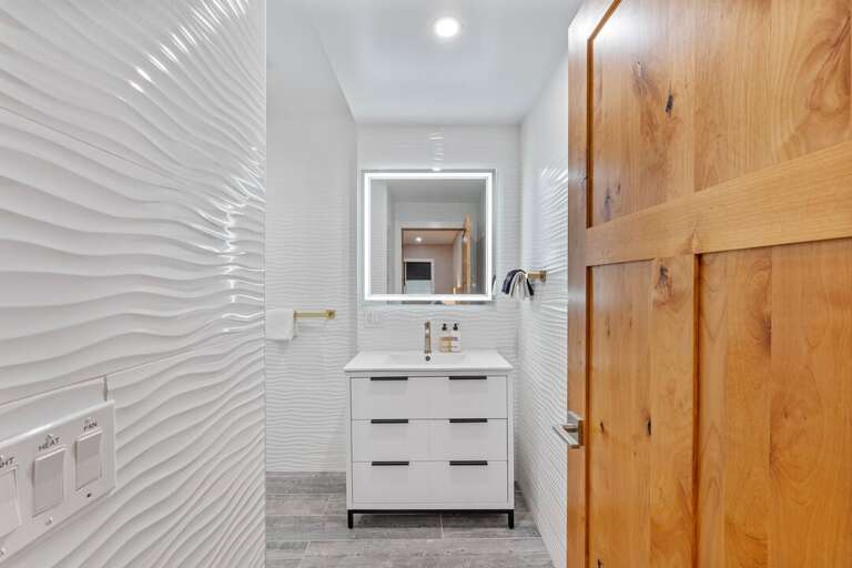 Bedroom 5 Private Bath Vanity with a Lighted Mirror | Lower Level Bedroom 5 Private Bath Vanity with a Lighted Mirror | Lower Level