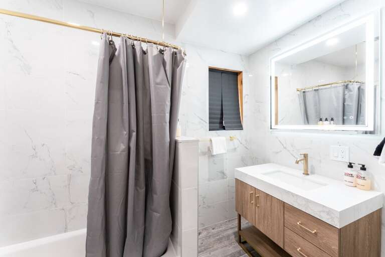 Lower Level | Bedroom 2 Private Bath with a Tub/Shower Combo Lower Level | Bedroom 2 Private Bath with a Tub/Shower Combo