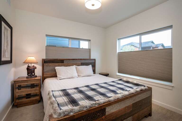 The master bedroom has a king-sized bed and tons of natural light | Lower Level