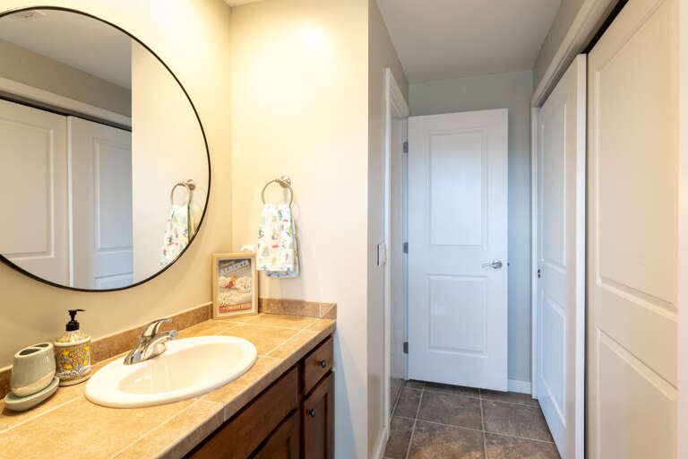 Ensuite Primary Bathroom | Large Round Mirror | Upper Level