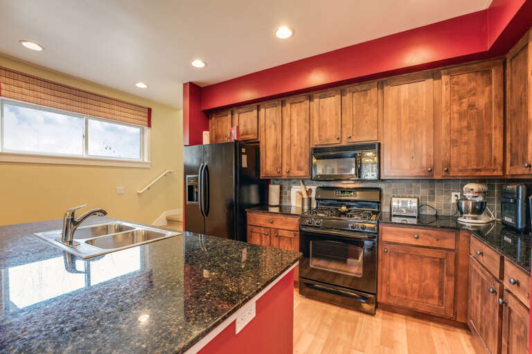 Red Accents Create a Vibrant Feel in the Kitchen | Main Level