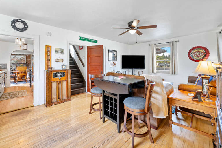 Open and rustic living room boasts cozy furnishings and an abundance of natural lighting | Main Level