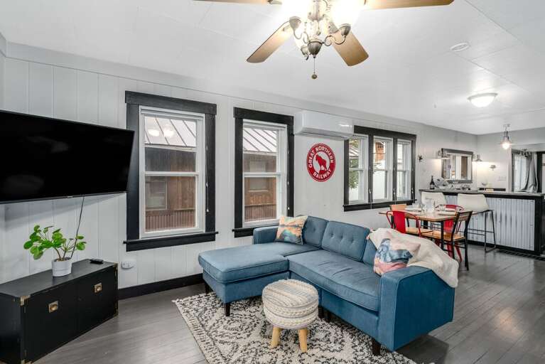 Lounge out on the cozy furnishings including a sectional sofa and Smart TV. | Main Level