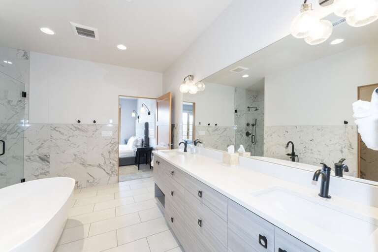 Summit Loft primary ensuite bathroom with dual vanity sink.