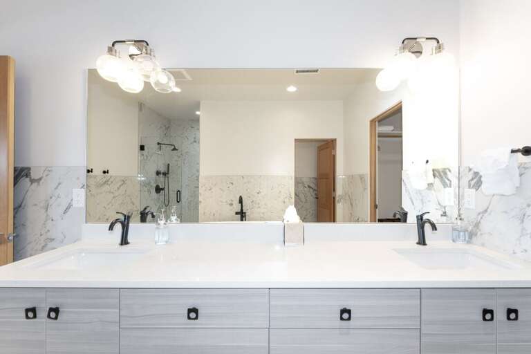 Summit Loft primary ensuite bathroom with dual vanity sink.