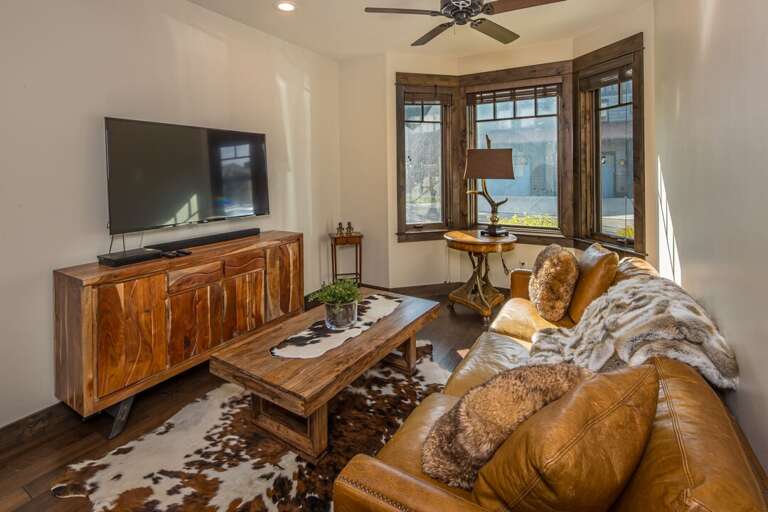 living room with cozy couch to watch TV and wind down | Main Level