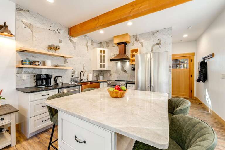 Kitchen With Marble Island, Rustic Beam, Stainless Steel Fridge