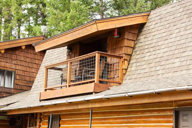 The balcony provides a serene space to breathe in the fresh mountain air.