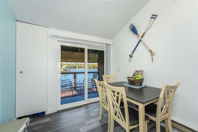 Dining area with seating for four and balcony access with breathtaking views of Echo Lake | Upper Level