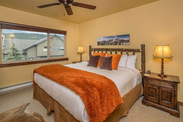 Escape to the primary bedroom with a king-sized bed | Upper Level