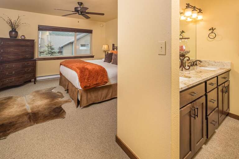 Primary bedroom includes a ceiling fan and an ensuite bathroom with | Upper Level