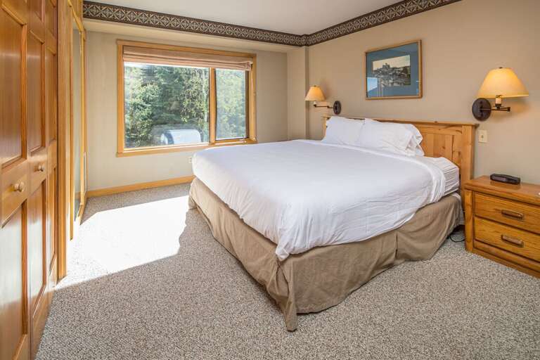 Primary bedroom with plush king bed and beautiful views | Main Level