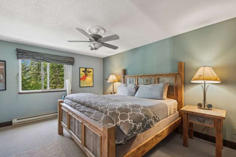 A king-size bed with nightstands, perfect for reading after a day of adventuring. | Upper Level
