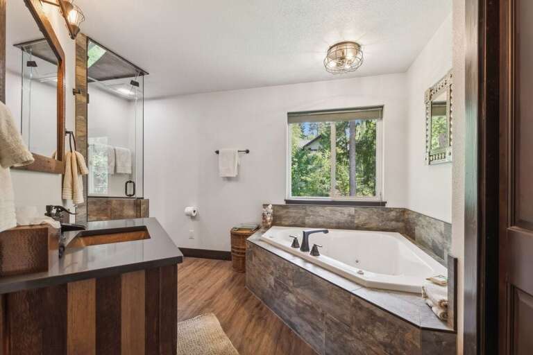 Newly renovated ensuite bathroom, featuring a large tub. | Upper Level