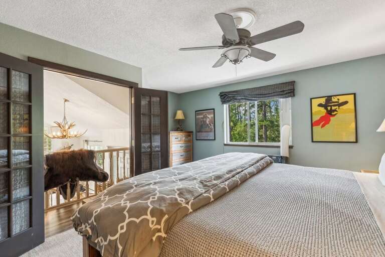 Primary bedroom that overlooks the living room. | Upper Level