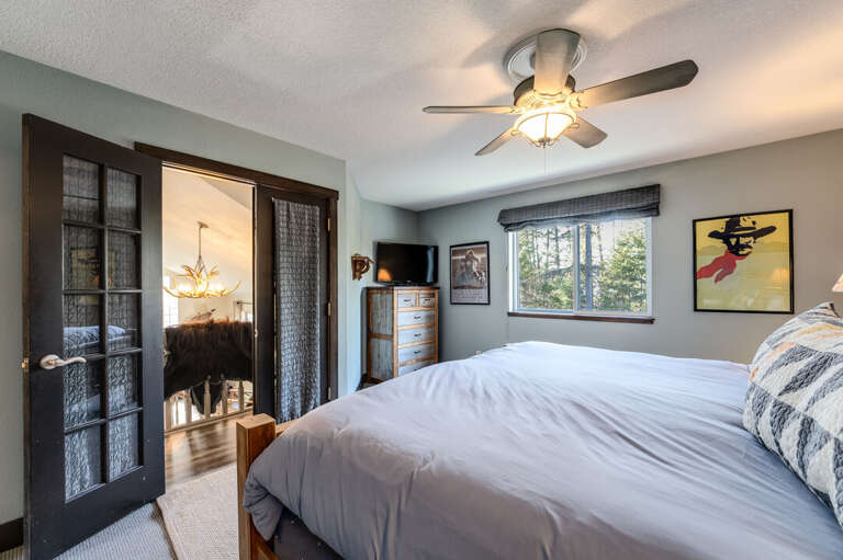 Primary bedroom that overlooks the living room. | Upper Level